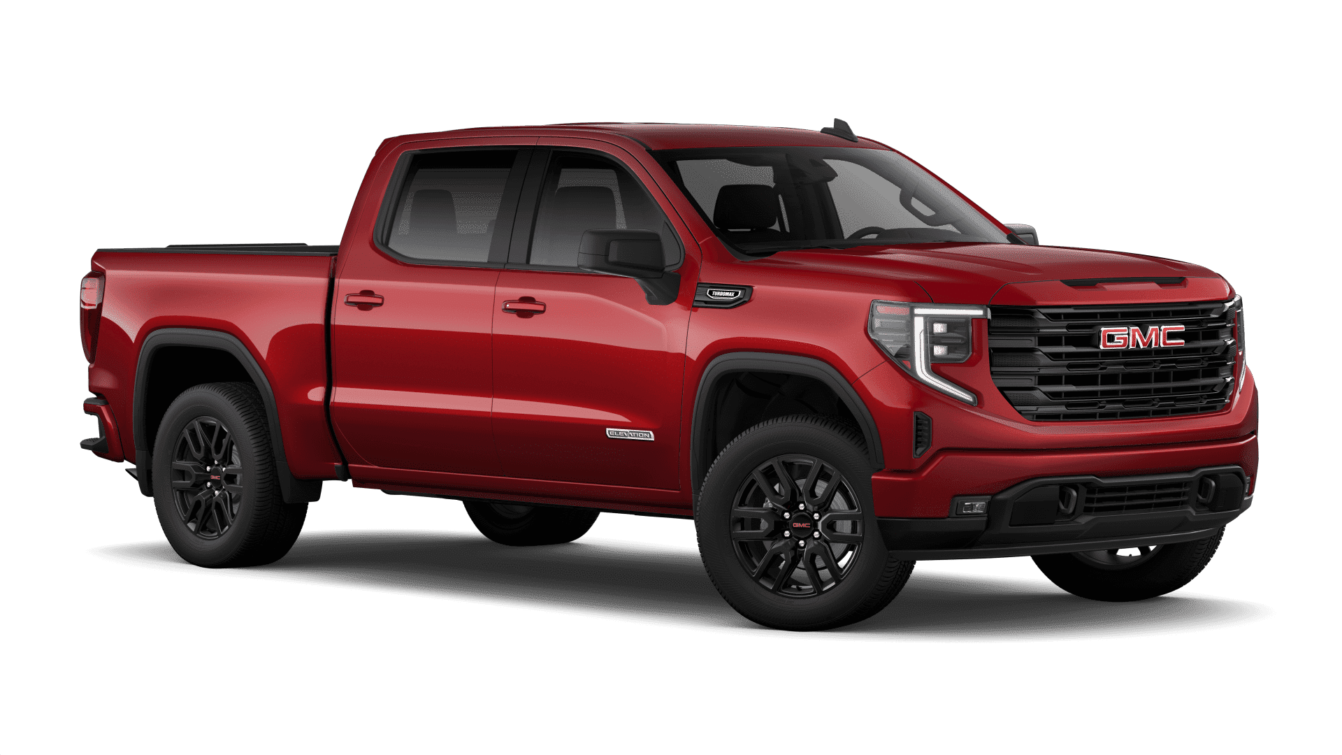 Red GMC pickup truck, side view, showcasing bold grille design and black wheels.