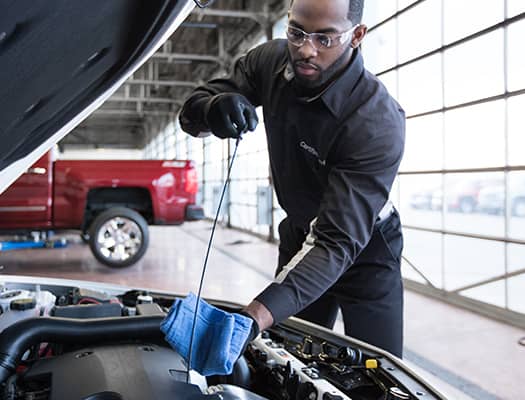 Mechanic adjusting a brake caliper on a car's brake system.