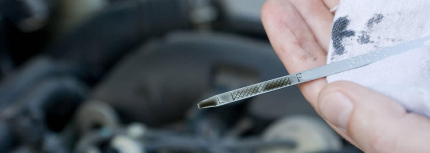 Motor oil being poured into an engine for maintenance.