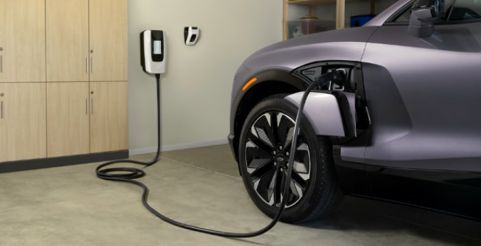 Close-up of an electric vehicle charging connector against a white background.
