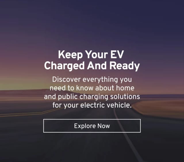 Text on a background of a road at dusk promotes electric vehicle charging solutions.