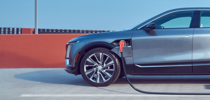 Electric car charging in a parking lot, highlighting eco-friendly transportation.
