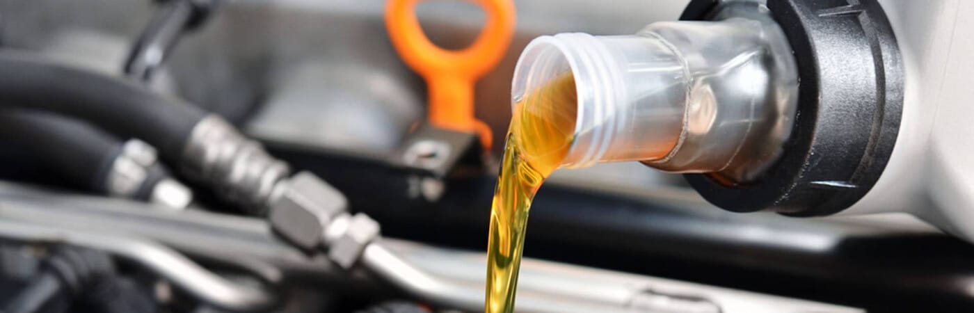 Motor oil being poured into an engine for maintenance.