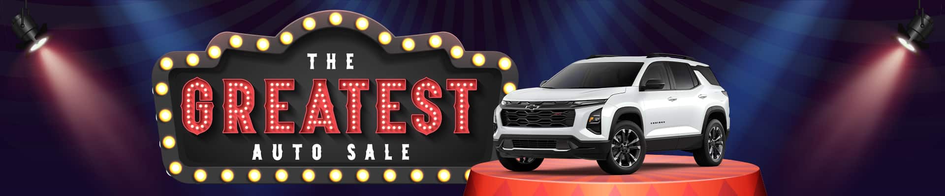 White SUV on display with marquee lights reading "The Greatest Auto Sale" under spotlights.