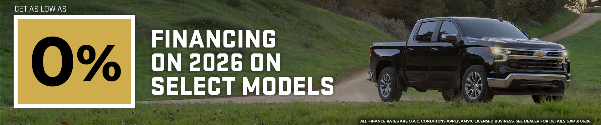 Pickup truck on country road offering 0% financing for 2026 models, promotional text included.